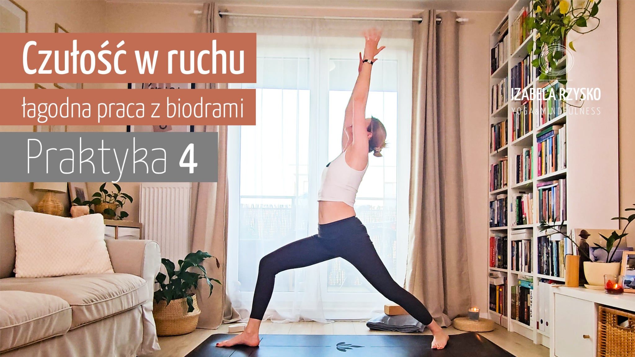 Kobieta ćwiczy jogę online w jasnym salonie, stojąc w pozie wojownika na macie. Tekst w języku polskim brzmi: Czułość w ruchu, łagodna praca z biodrami, Praktyka 4. W tle widoczne półki z książkami i rośliny.